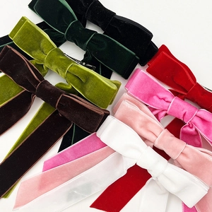 Elegant velvet bow hair clips with long streamers in multiple colors on white background