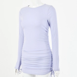 Detailed close-up of light purple ribbed knit fabric and adjustable side drawstrings on dress