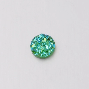 Macro shot of 6mm green iridescent resin druzy stone with sparkling mineral texture