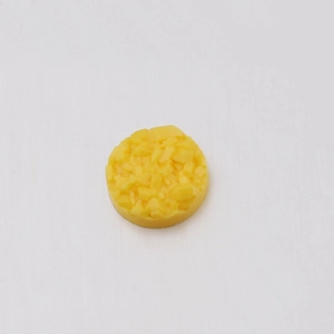 Macro detail of 6mm yellow resin flatback rhinestones with textured starry ore finish