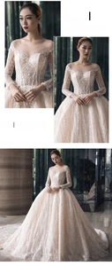 Detail of champagne bridal gown with heavy sequin embroidery and long mesh sleeves