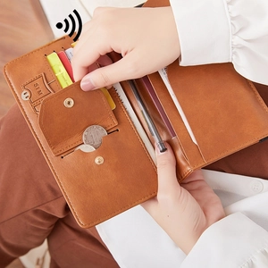 Brown leather travel wallet with RFID protection, showing large capacity and card slots
