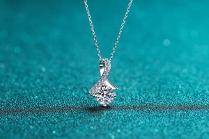 Macro shot of silver S925 necklace pendant with circular main stone and pavé setting