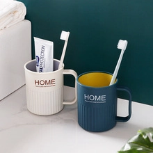 Detail of cream and navy blue bear toothbrush cups for travel on a modern washstand
