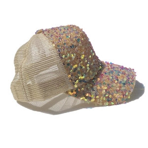 Macro detail of iridescent sequins and breathable mesh on a stylish trucker cap