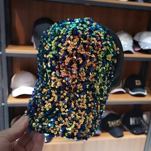 Close-up of iridescent dragon scale sequins on a mesh breathable baseball cap brim