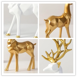 Detailed views of Nordic resin deer statues with geometric facets in white and gold finish