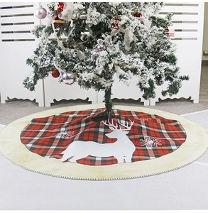 Detail view of burlap Christmas tree skirt with red plaid design and reindeer patterns