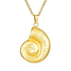 Macro detail of a 18K gold plated nautilus pendant necklace with fine metal chain