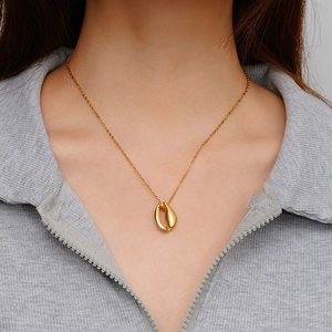 18K gold plated stainless steel necklace with a polished seashell pendant on model