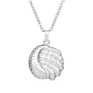 Macro shot of silver golf ball pendant necklace with detailed texture and fine metal chain