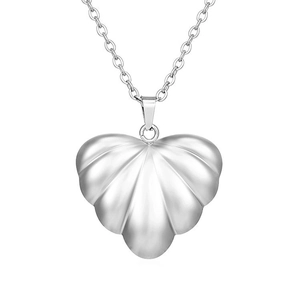 Macro shot of silver heart pendant with unique ribbed texture on a fine chain link