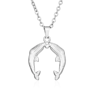 Detailed view of silver-tone double dolphin pendant necklace with polished mirror finish