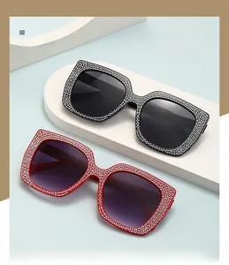 Macro shot of oversized square cat-eye sunglasses with sparkling rhinestone embellishments