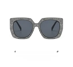 Detailed view of oversized square cat eye sunglasses with white rhinestones decoration