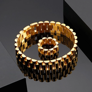 Detail of gold stainless steel watch-band style bracelet and ring set for men