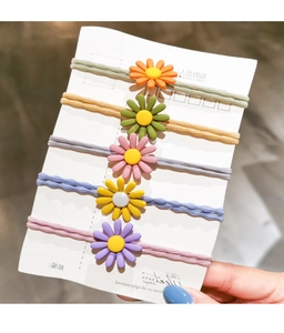 Detailed set of five colorful woven daisy hair ties in orange, green, pink, yellow, and purple