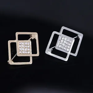Square geometric brooch pins with white crystals in gold and silver finishes