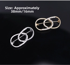 Detail of interlocking rhinestone brooches in gold and silver finish with size markings
