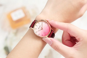 Close-up of women's quartz watch showing gradient floral dial and magnetic mesh band
