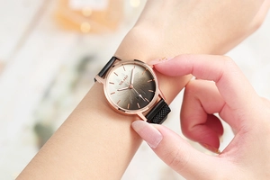 Detailed view of women's rose gold watch with gradient flower dial and magnetic mesh strap