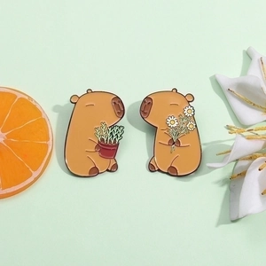 Cute capybara enamel pin set featuring floral and potted plant designs in brown metal