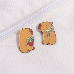 Cute Capybara enamel pin set featuring two pins with flowers on white canvas background