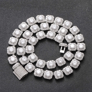 Macro detail of silver iced out tennis chain with square links and pave diamonds