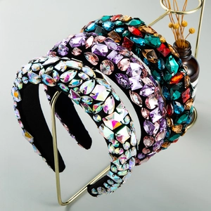 Baroque style wide headbands with colorful crystals and pearls on elegant display stand