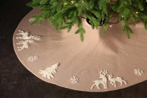Detail of knitted Christmas tree skirt featuring 3D reindeer and snowflake patterns