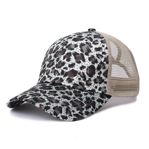 Detail of leopard print trucker hat featuring breathable khaki mesh and curved brim