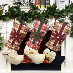 Close-up of three festive Christmas stockings with Santa, snowman and penguin motifs