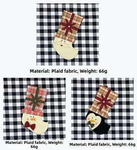 Detail view of plaid Christmas stockings with Santa, Snowman and Penguin designs
