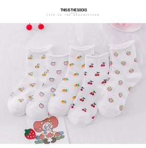 Close-up of five pairs of white cotton crew socks with colorful fruit patterns and rolled cuffs