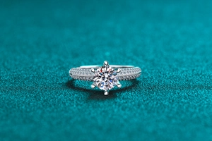 Macro shot of silver ring with Moissanite stone in classic six-prong setting