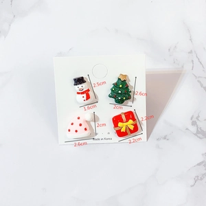 Close-up of 4 Christmas acrylic brooch pins with detailed size measurements on card