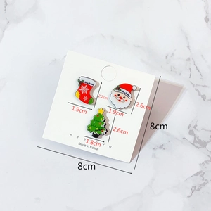 Detail view of cartoon Christmas acrylic brooch set with snowman and tree on card