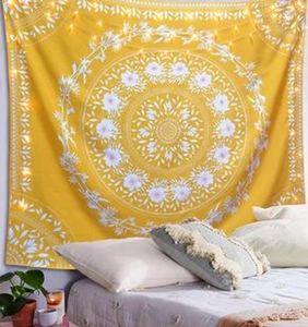 Detail of yellow mandala tapestry with white floral patterns and cozy fairy lights decoration