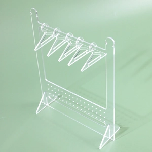 Macro shot of transparent acrylic jewelry organizer with earring hanger and multiple holes