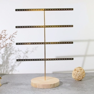 Golden 4-tier metal jewelry display stand with natural wooden base for earrings