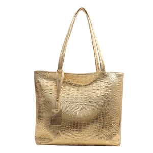 Metallic gold crocodile pattern tote bag with dual shoulder straps and metal tag