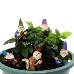 Garden miniature set with resin gnomes and a squirrel placed in a potted plant soil