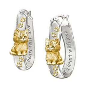 Detail of silver cat earrings with gold accents and fill a heart with love engraving