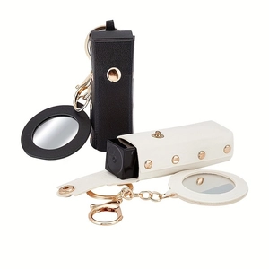 Mini leather lipstick holder keychain in black and white with gold metal hardware and mirror