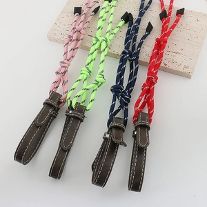 Detail of colorful braided eyewear lanyards with brown leather connectors and white stitching