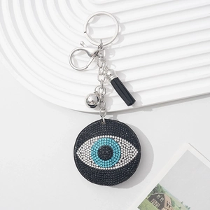 Evil eye keychain with blue rhinestones and black tassel on a silver metal ring