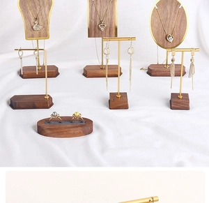 Detailed walnut wood and gold metal jewelry display stands for earrings and necklaces