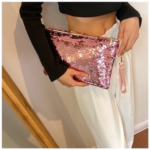 Detailed shot of pink sequin mini clutch bag with zip closure and matching wrist strap
