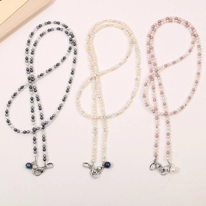 Detailed view of beaded lanyard chains in black, cream, and pink with metal lobster clasps