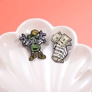Cartoon dollar banknote and skull enamel pins set on a white shell decorative tray